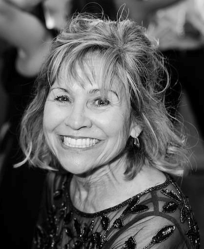 Black and white portrait of Sue Kelly smiling